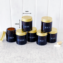 Load image into Gallery viewer, Set Of 7 Mini Amber Glass Jars With Gold Lids And Stamped Labels
