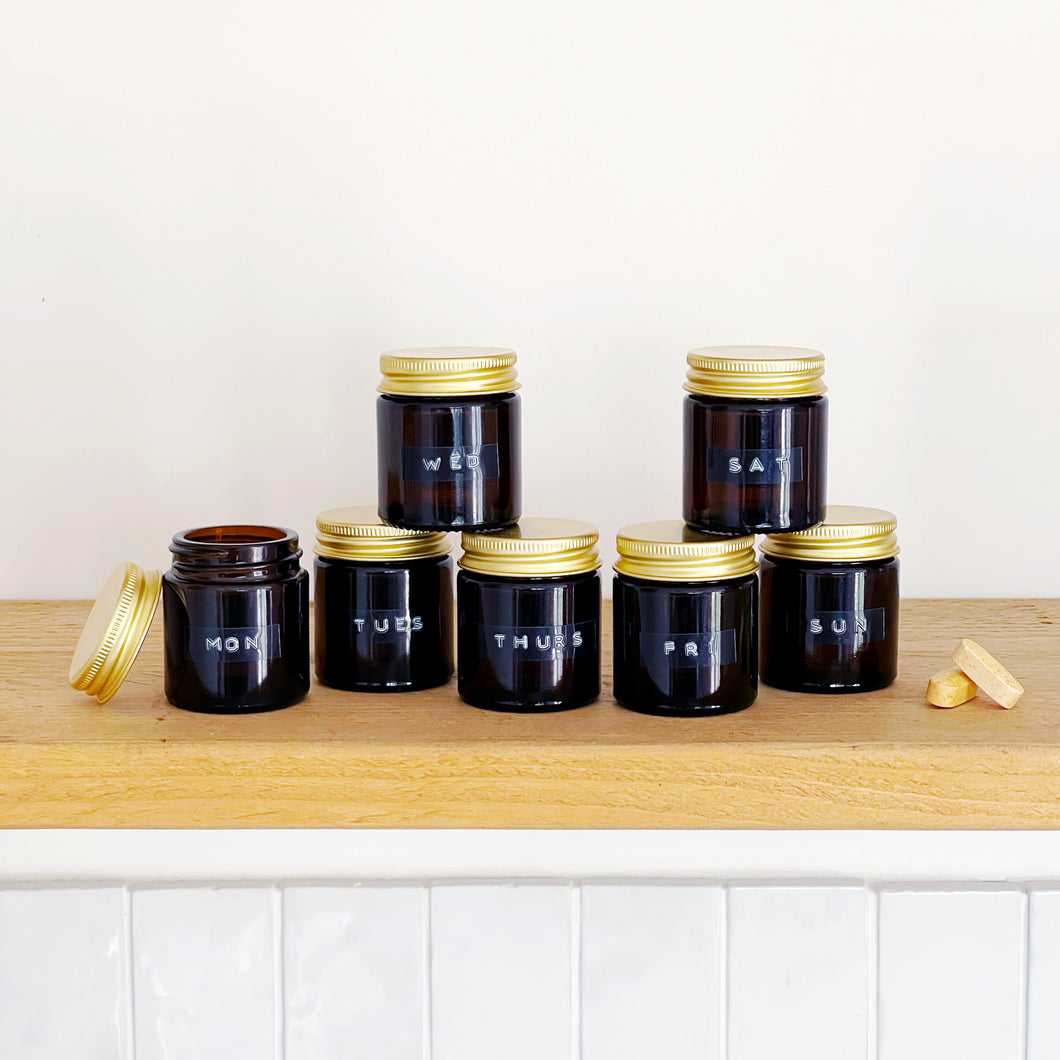 Set Of 7 Mini Amber Glass Jars With Gold Lids And Stamped Labels