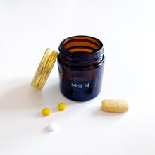 Load image into Gallery viewer, Set Of 7 Mini Amber Glass Jars With Gold Lids And Stamped Labels
